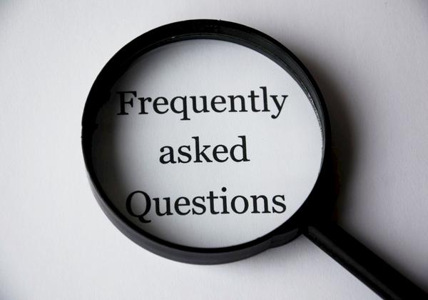 magnifying glass showing words frequently asked questions