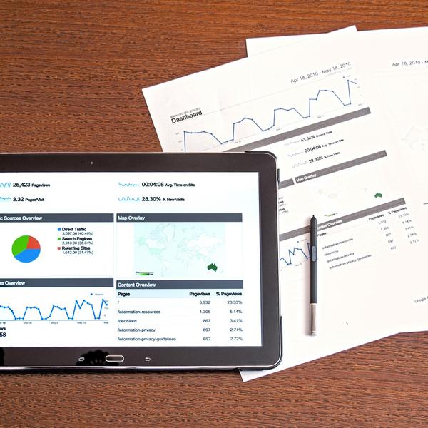 Image of analysis charts on a tablet and paper charts next to it.